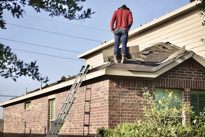 Professional roofer working on a residential roof in New England Estates